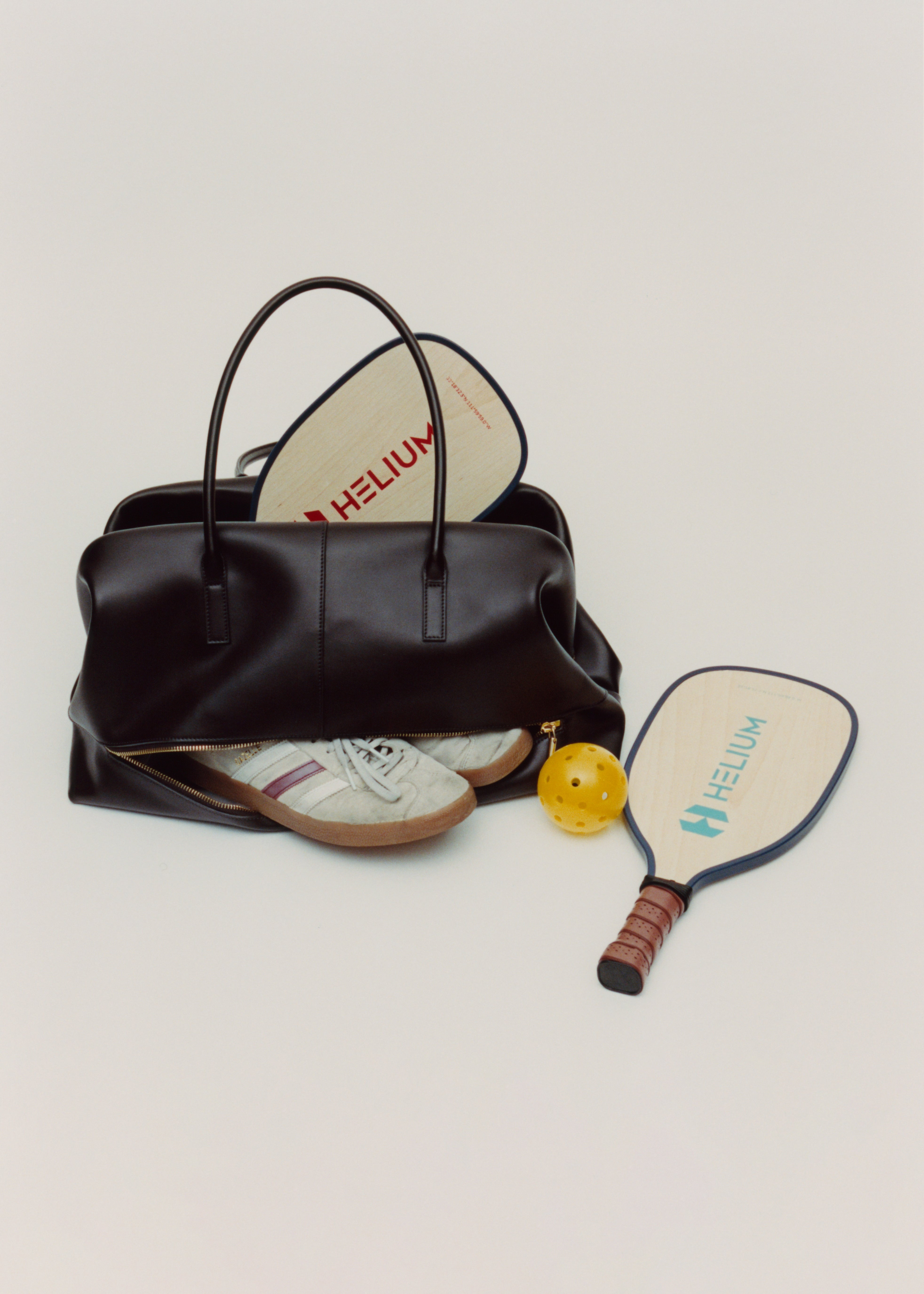 Chocolate Club Large Handbag with a pickleball paddle and ball on a light gray background