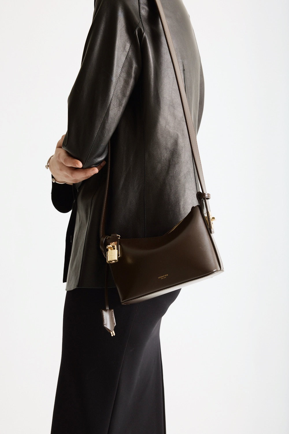 A person with a Mini Gold Chocolate Hobo Shoulder Handbag