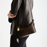 A person with a Mini Gold Chocolate Hobo Shoulder Handbag