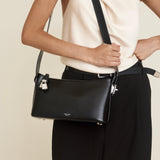 Person wearing a Silver Black Hobo Shoulder Handbag with a neutral background
