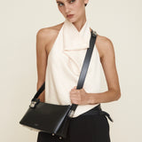 Woman holding a Silver Black Hobo Shoulder Handbag against a plain background