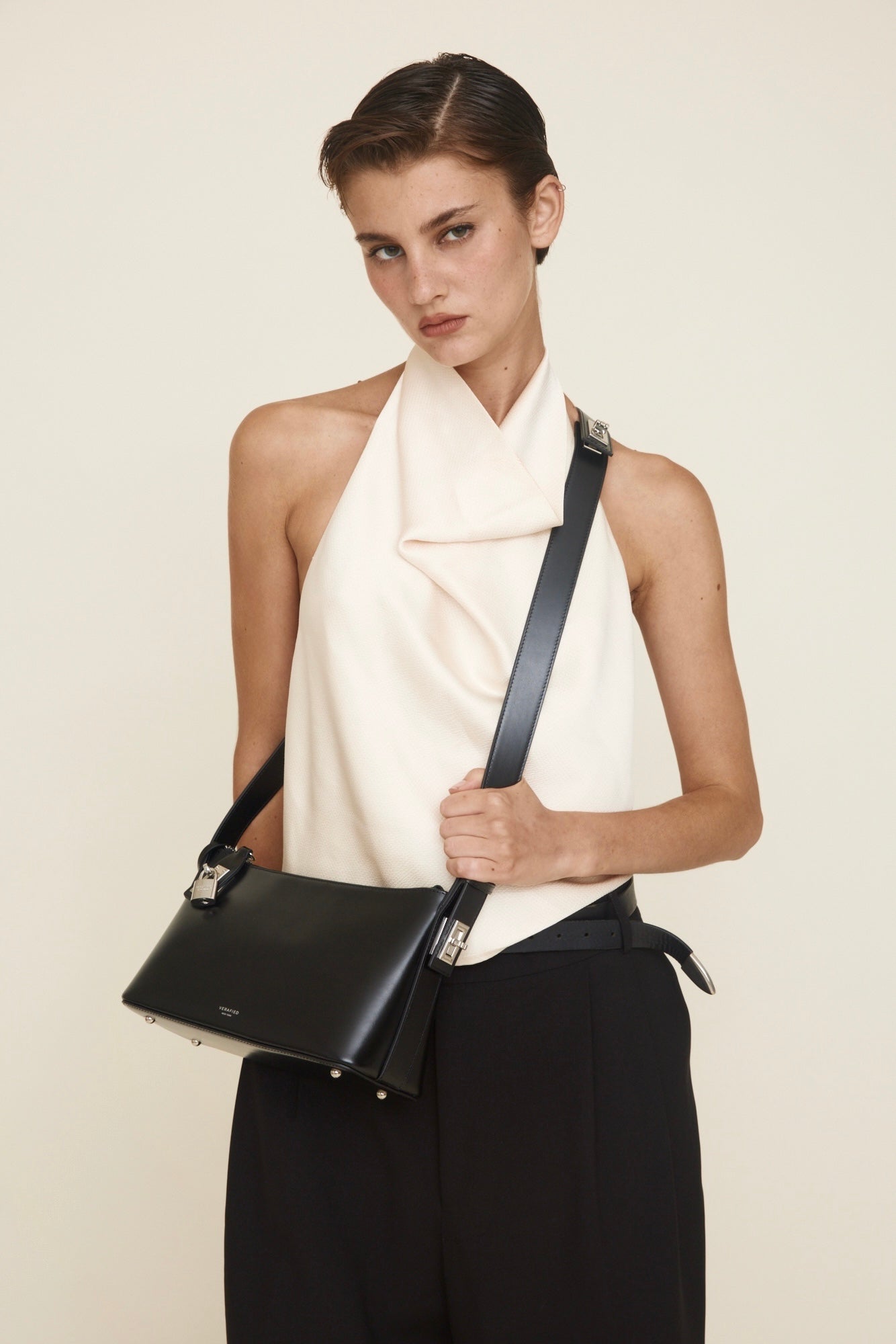 Woman holding a Silver Black Hobo Shoulder Handbag against a plain background