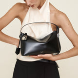Woman holding a Silver Black Hobo Shoulder Handbag against a plain background