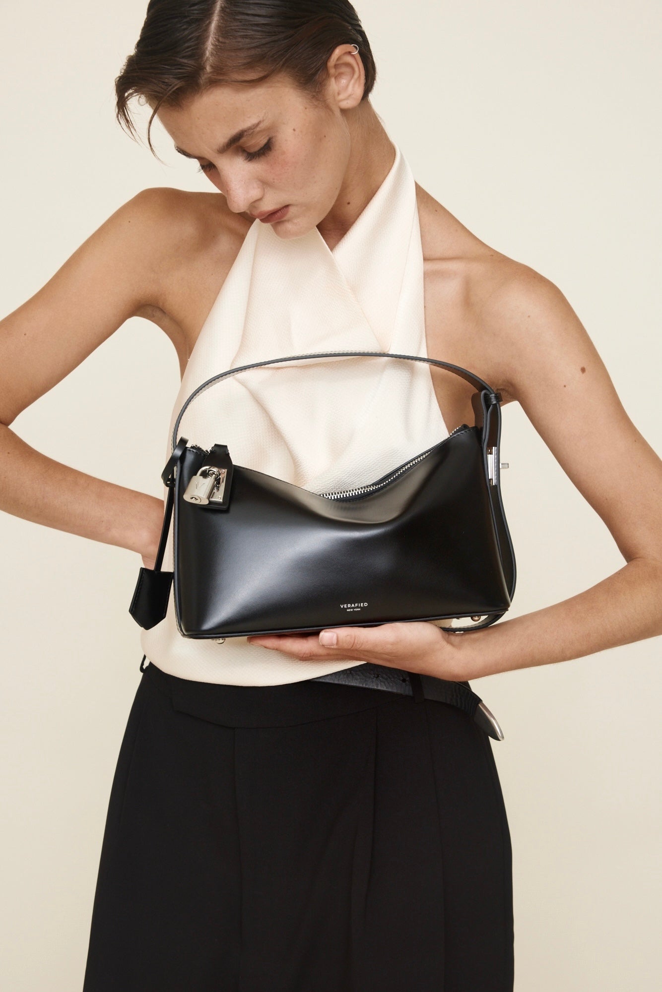 Woman holding a Silver Black Hobo Shoulder Handbag against a plain background