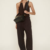 Woman in a brown outfit holding a Gold Black Hobo Shoulder Handbag against a white background
