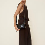 Woman holding a Mini Gold Black Hobo Shoulder Handbag against a plain background