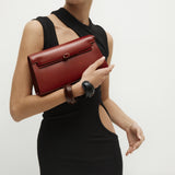 Woman holding a Dark Cherry Shoulder Purse Handbag against a plain background