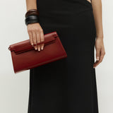 Person holding a Dark Cherry Shoulder Purse Handbag against a plain background