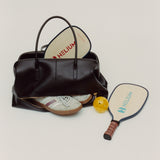 Chocolate Club Large Handbag with a pickleball paddle and ball on a light gray background