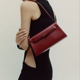 Woman holding a Dark Cherry Shoulder Purse Handbag against a plain background