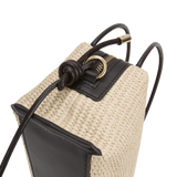 Close-up of a Raffia Café Mini Crossbody Handbag with black accents on a white background