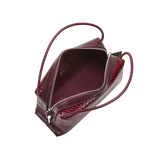 Maroon handbag with a shoulder strap on a white background