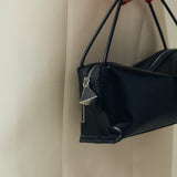 Verafied New York Black Lizard Café Mini Handbag held by a person against a neutral background