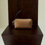 Verafied New York Gold Suede Café Mini Handbag on a dark wooden stand against a plain background