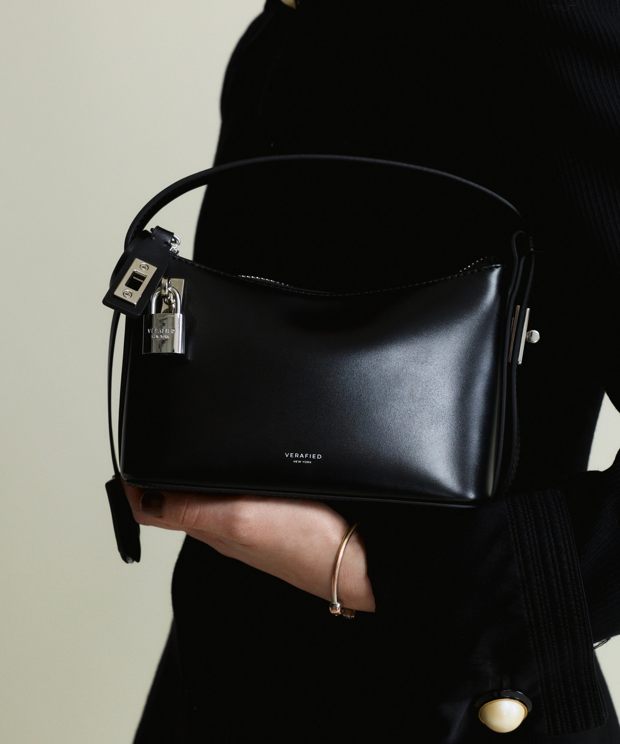 Mini Silver Black Hobo Shoulder Handbag held by a person against a neutral background