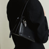 Person wearing a Mini Silver Black Hobo Shoulder Handbag with a neutral background