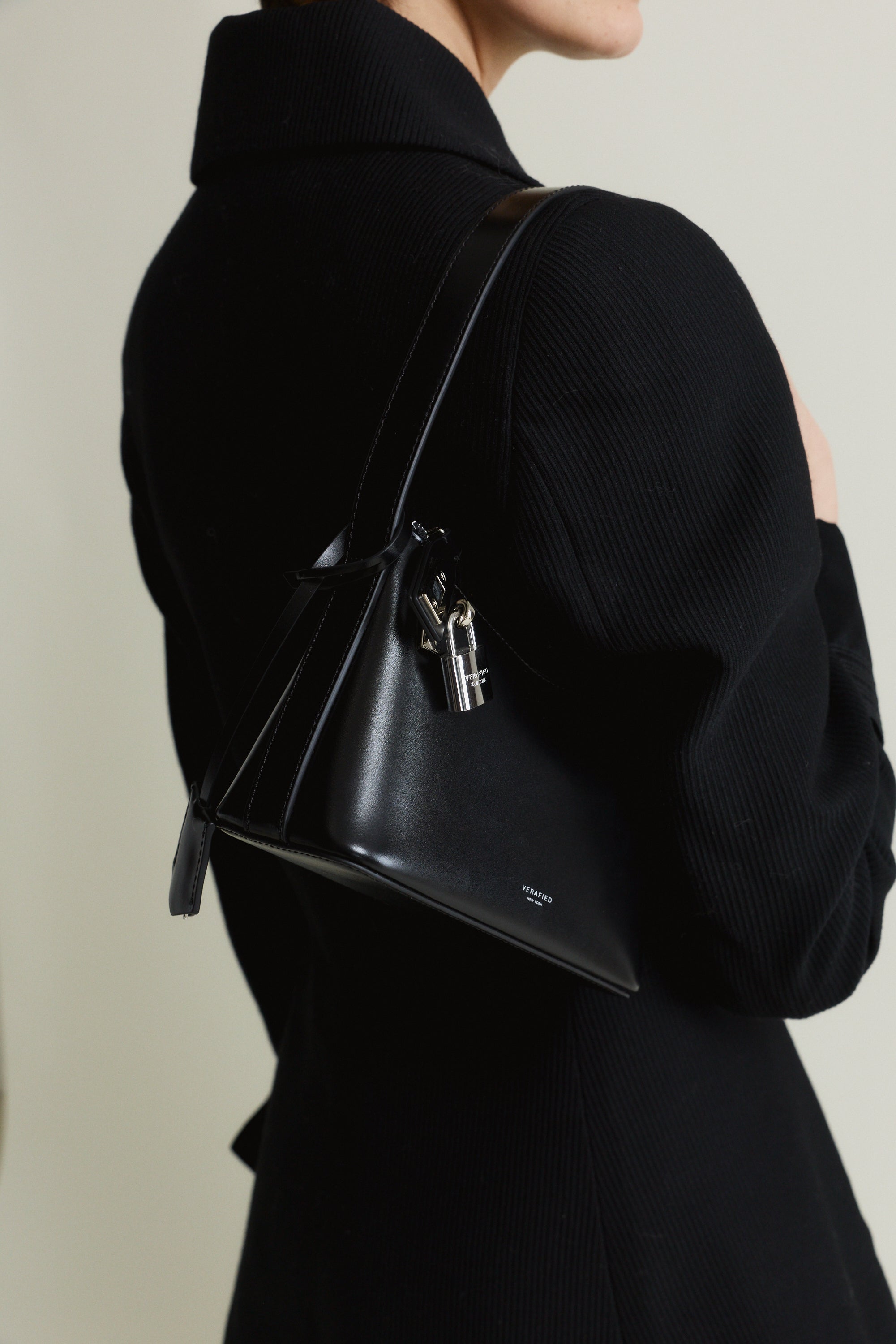Person wearing a Mini Silver Black Hobo Shoulder Handbag with a neutral background
