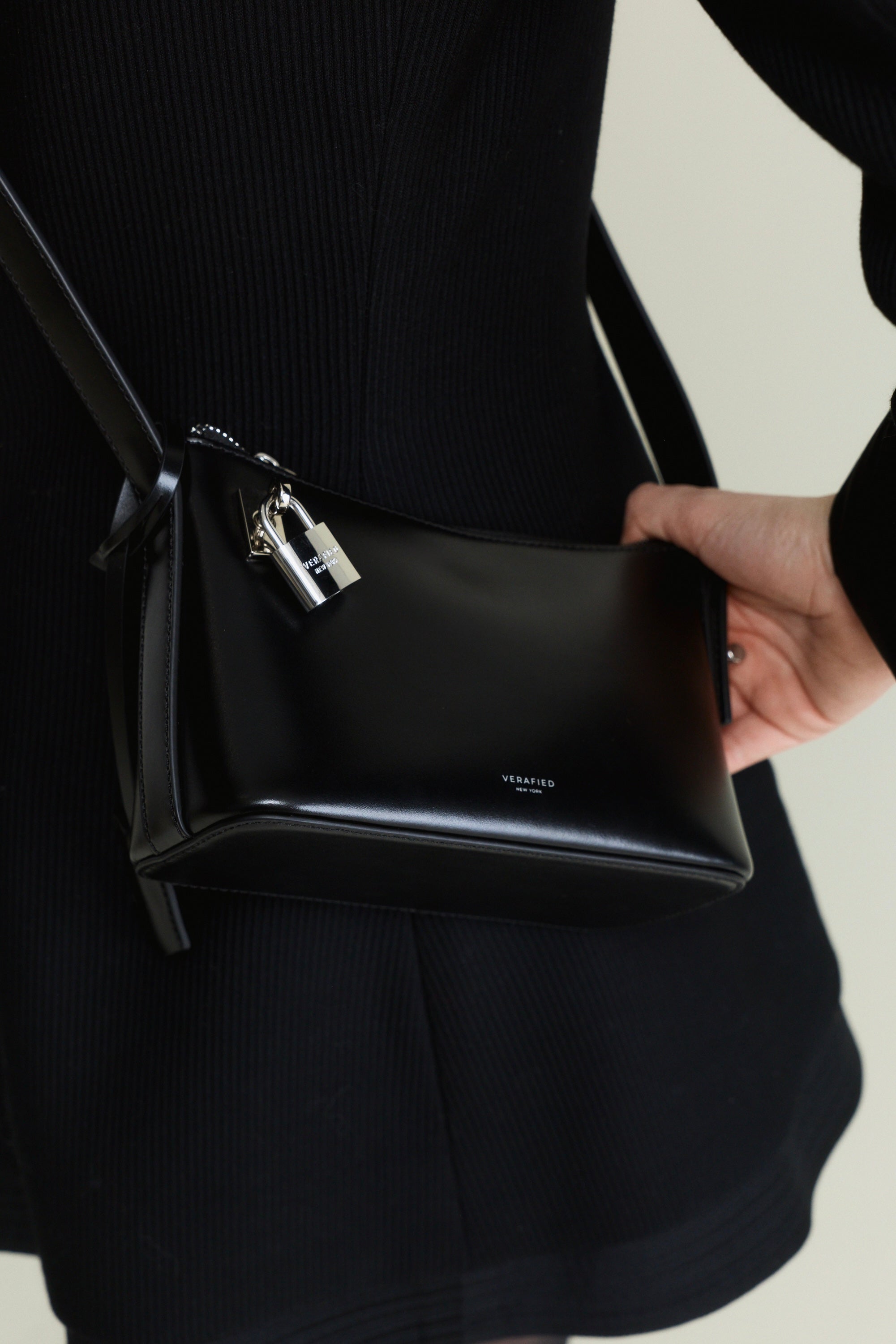 Person holding a Mini Silver Black Hobo Shoulder Handbag with a visible brand name.