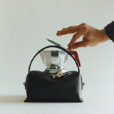 Chocolate Café Mini Crossbody Handbag with a silver coffee maker on a light gray background