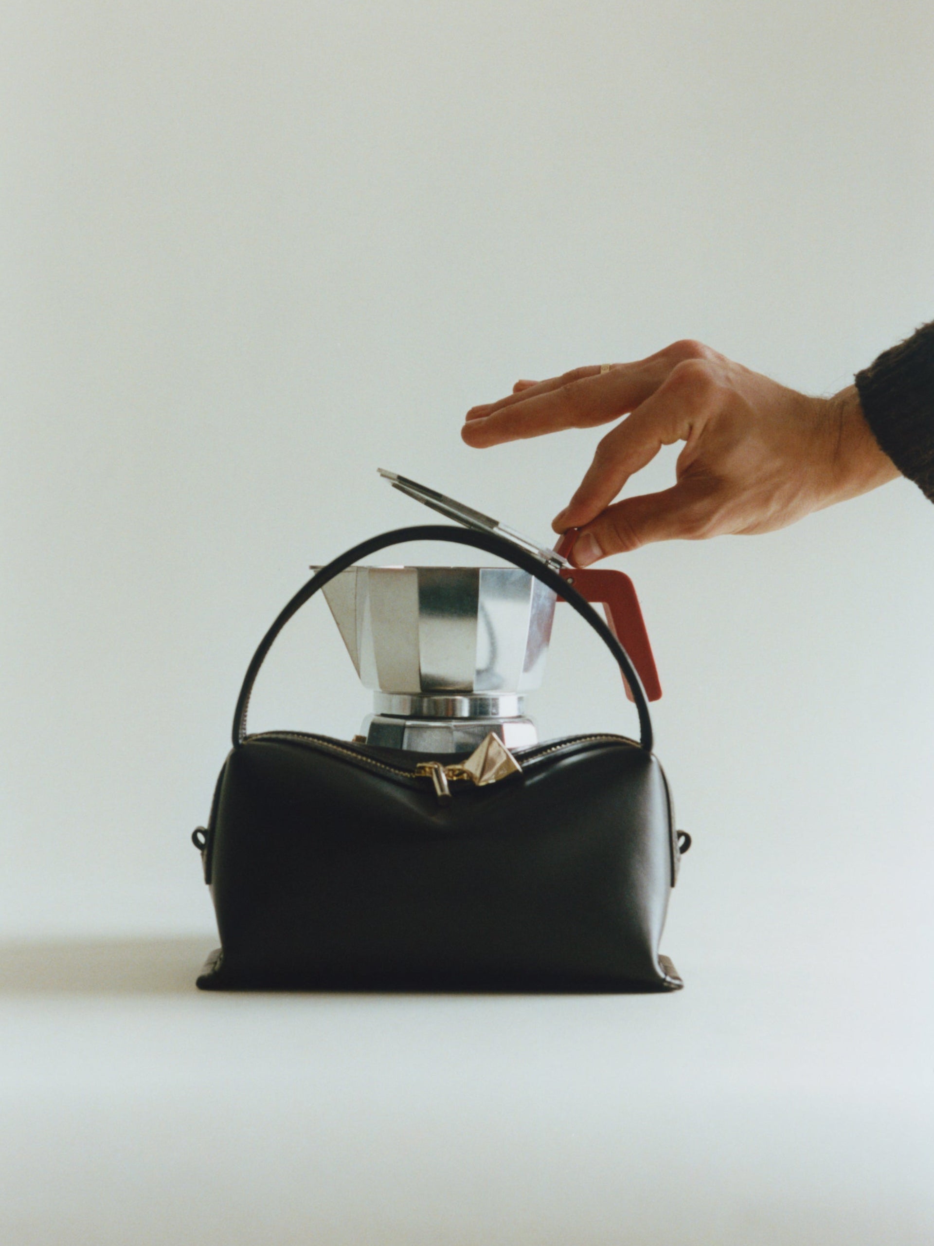 Chocolate Café Mini Crossbody Handbag with a silver coffee maker on a light gray background
