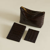 Set of Mocha Croc Makeup Pouches and cardholder on a beige background