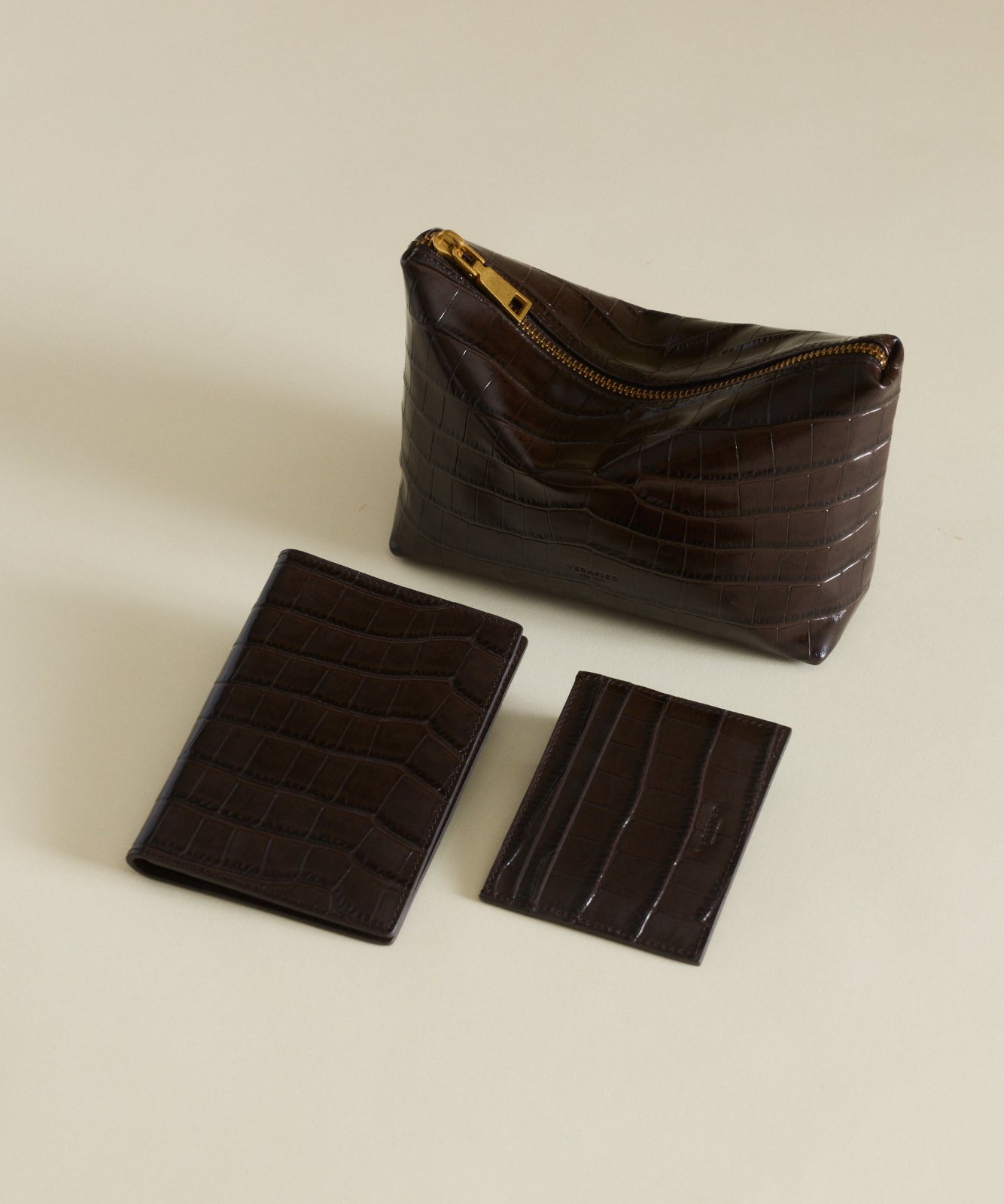 Set of Mocha Croc Makeup Pouches and cardholder on a beige background