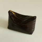 Mocha Croc Makeup Pouch bag on a beige background