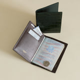 Mocha Croc Embossed Passport Cover Wallet with open cover displaying a passport and card on a beige background