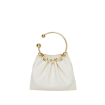 A cream-colored mini Cream Circle Ring Handle Bag with a gold-plated ring handle.