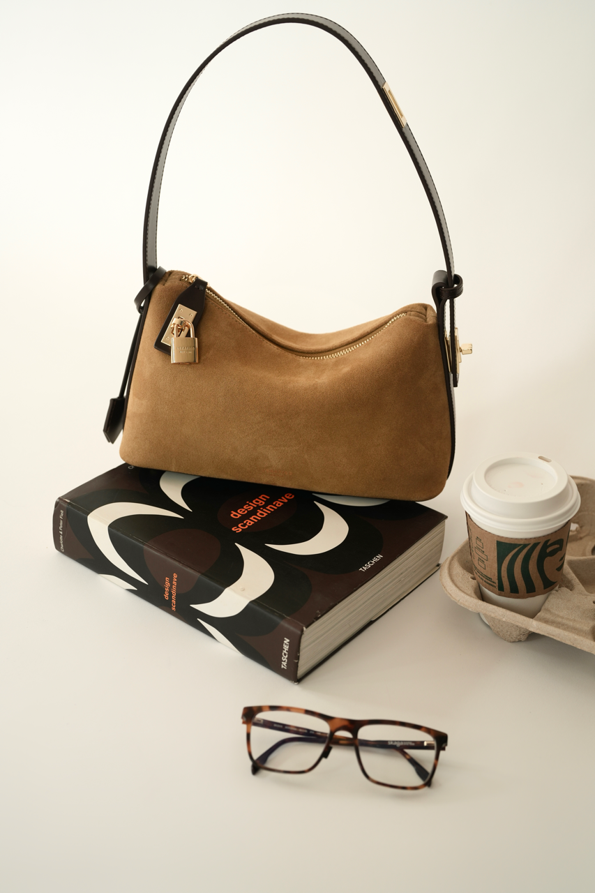 Gold Suede Hobo Shoulder Handbag and a book