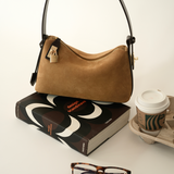 Gold Suede Hobo Shoulder Handbag and a book
