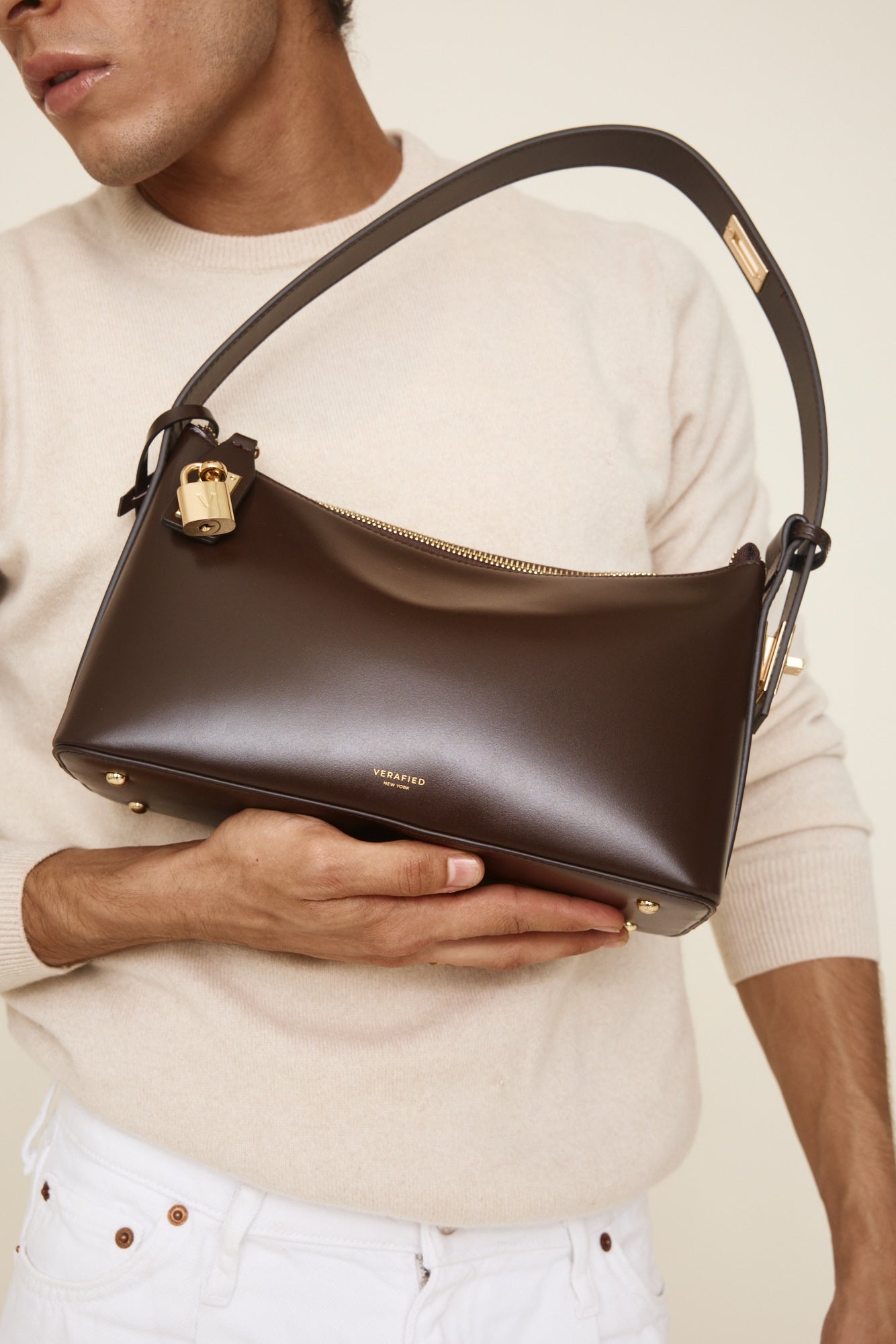 Person holding a Gold Chocolate Hobo Shoulder Handbag with visible brand name on a neutral background