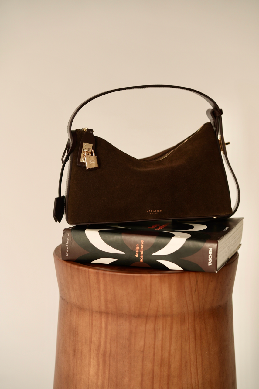 Gold Espresso Suede Hobo Shoulder Handbag on top of a book