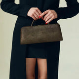 Person holding a Olive Calf Hair Clutch Shoulder Handbag with a plain background