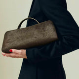 Person holding a Olive Calf Hair Clutch Shoulder Handbag against a neutral background